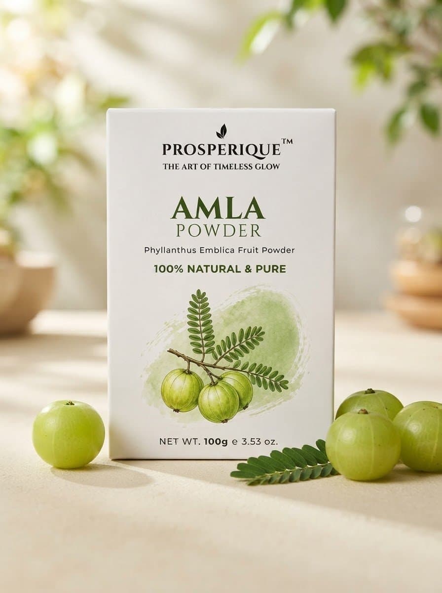 A product shot of Prosperique Amla Powder packaging surrounded by fresh amla fruit.